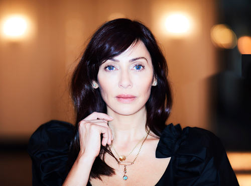 Natalie Imbruglia, nineties pop star, holding a delicate chain around her neck
